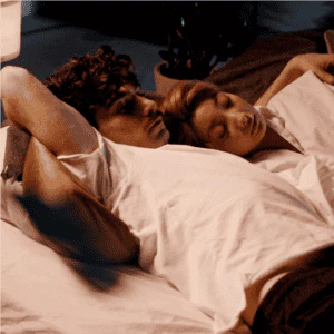 Couple lying in emotional distress, representing trauma bonds and relational healing