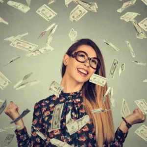 Woman celebrating financial success, symbolising business astrology money potential – Soul Awakening Academy.